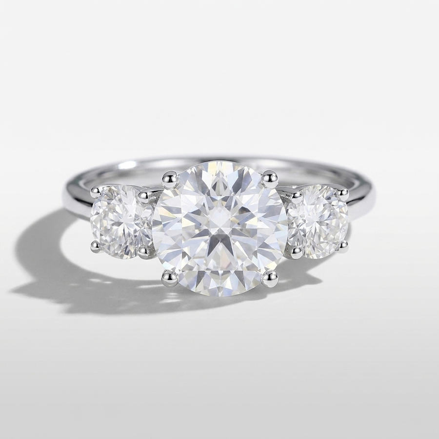 Three stone round diamond engagement ring on a minimal band