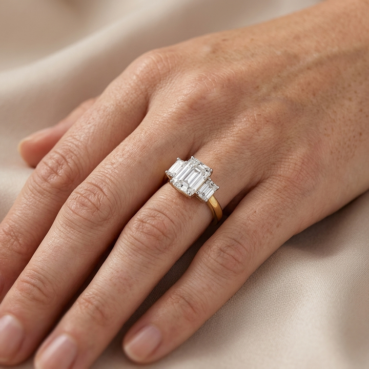 Three stone emerald cut diamond engagement ring, detail view