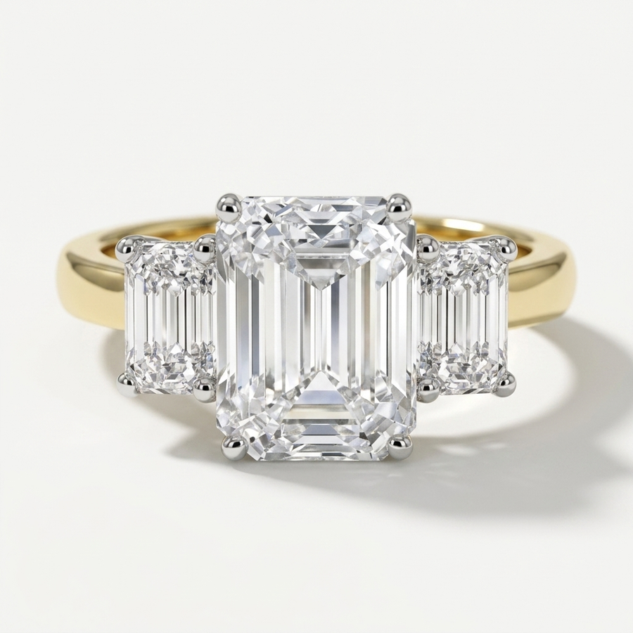 Three stone emerald cut diamond engagement ring on a minimal band