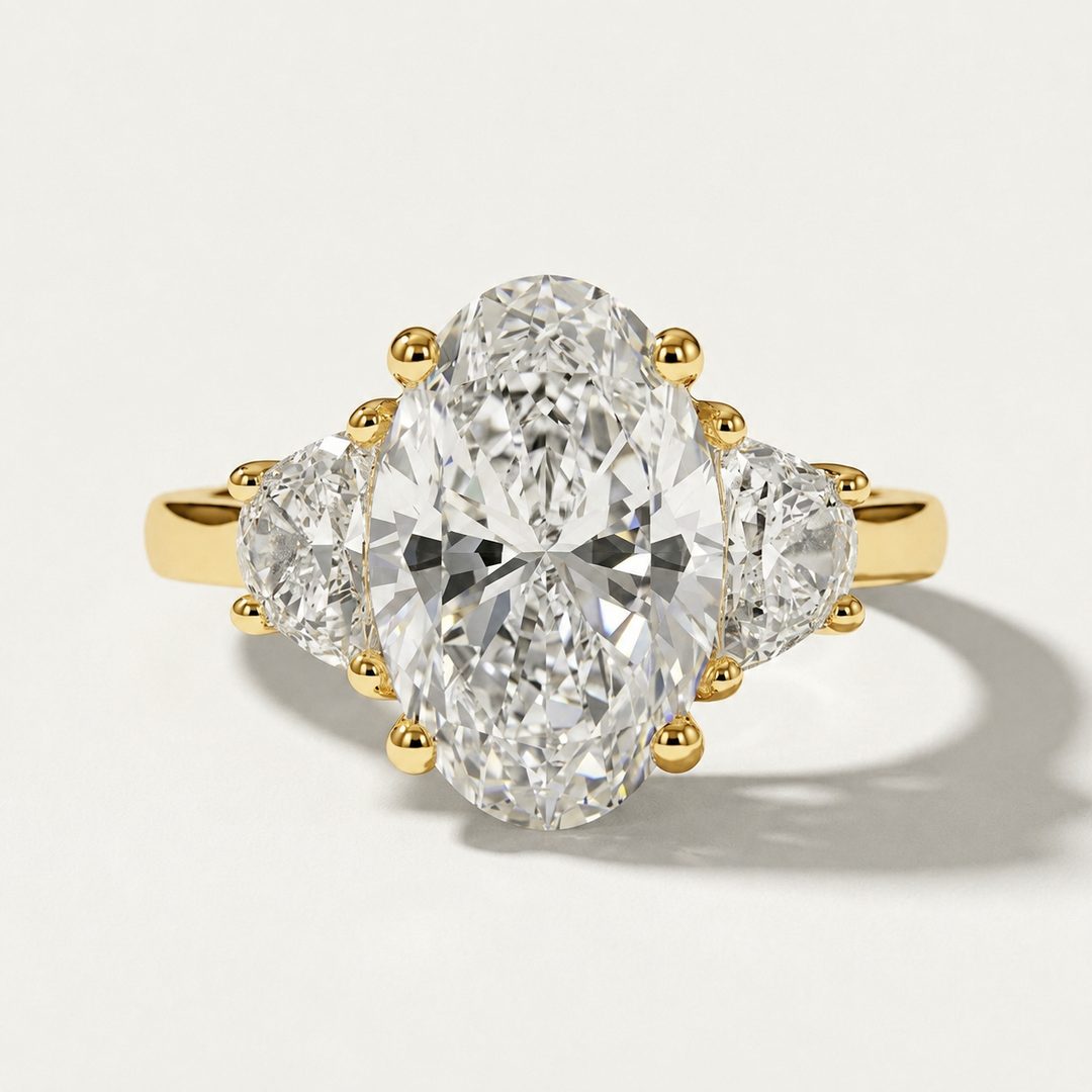 Oval and half moon three stone engagement yellow gold ring