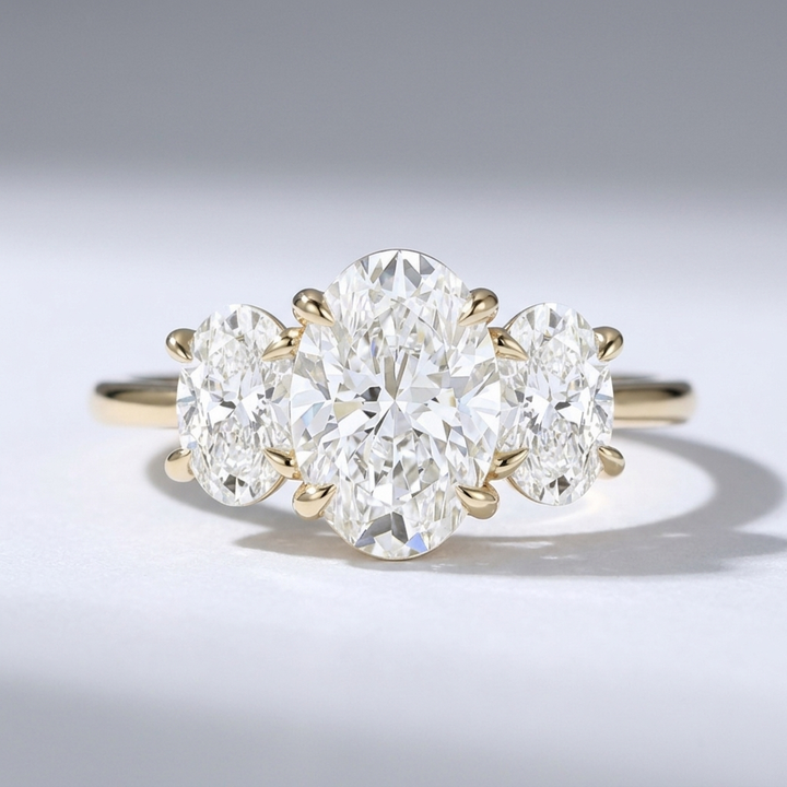 Three stone oval diamond engagement ring on a minimal band