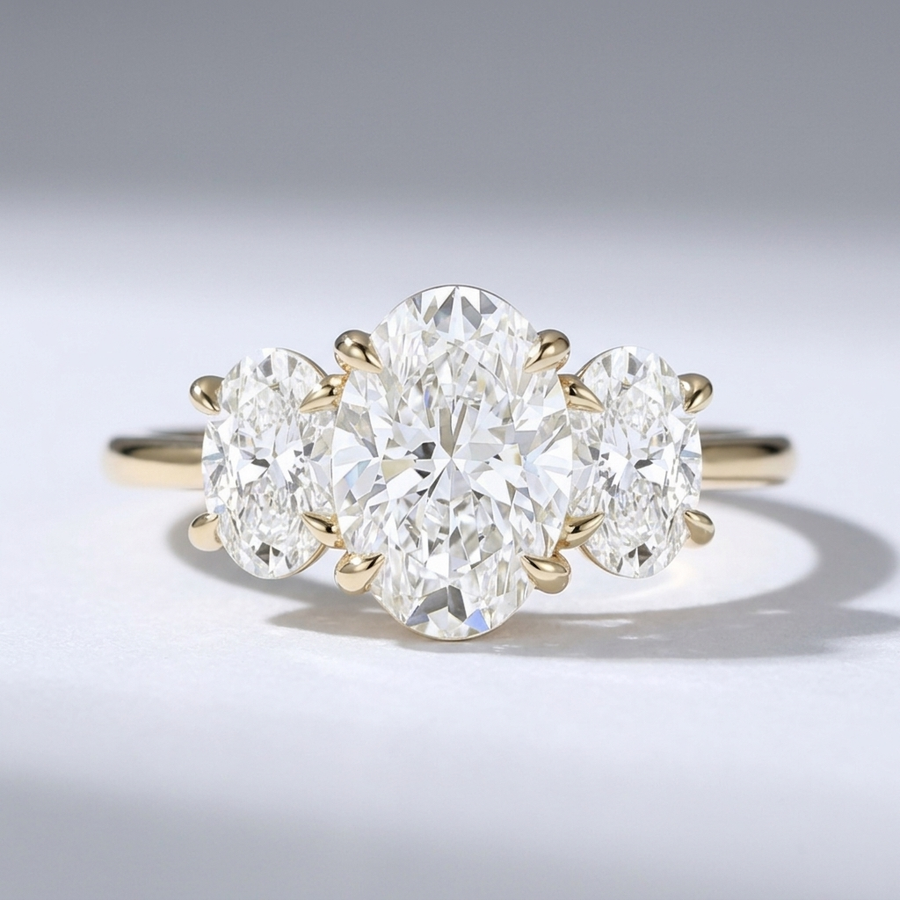 Three stone oval diamond engagement ring on a minimal band