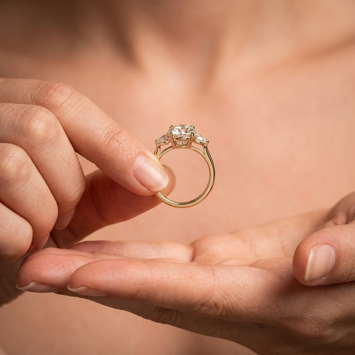 Round and pear three stone engagement ring, additional view