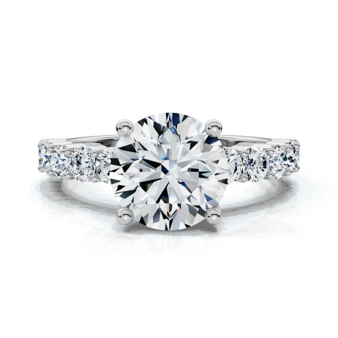 Sophisticated accented round shared prong ring featuring a brilliant round-cut center diamond, complemented by shimmering accent stones in a timeless shared prong setting.