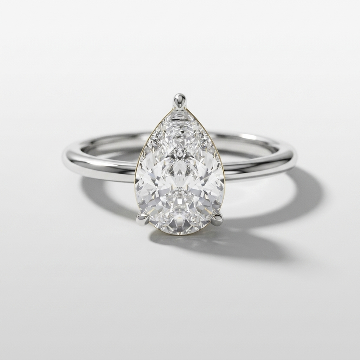Pear shaped diamond solitaire engagement ring with a hidden halo