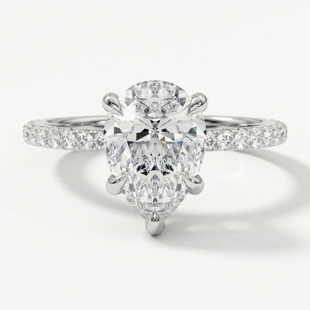 Pear diamond engagement ring on a petite diamond set band