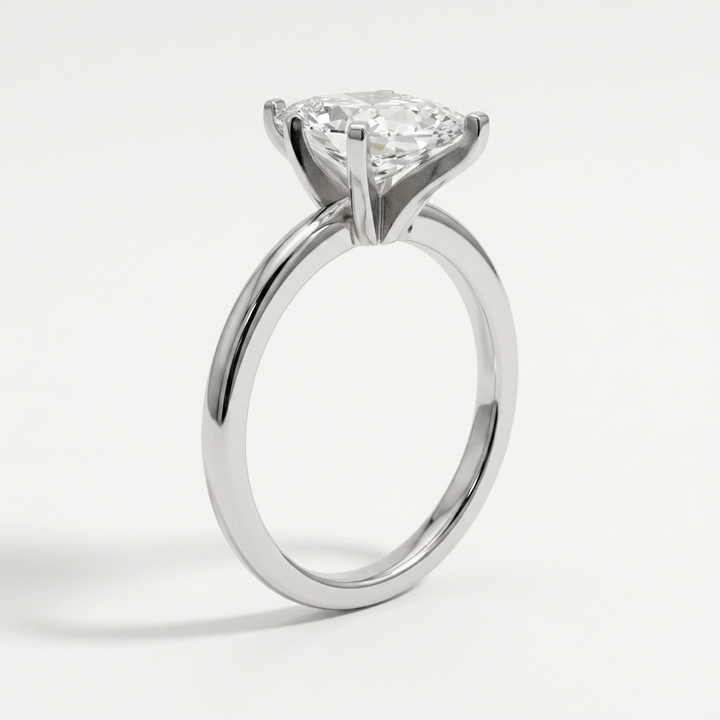 A white gold diamond engagement ring with a round brilliant-cut center stone in a six-prong setting, shown on a clean white background.