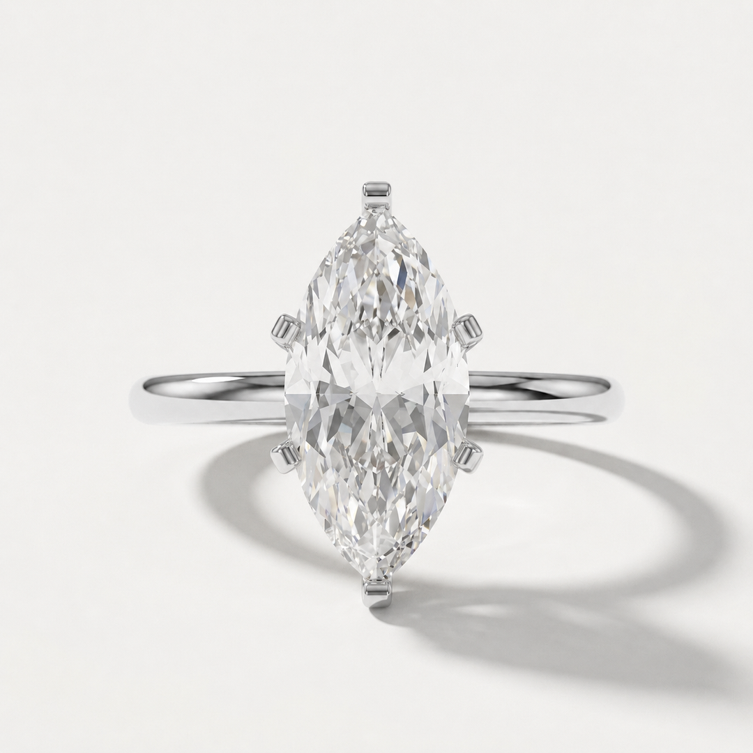A white gold ring featuring a large marquise-cut clear gemstone in a four-prong setting, shown on a clean white background with a soft shadow.