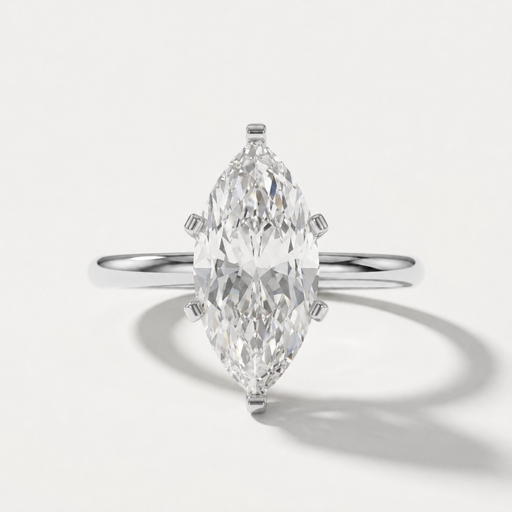 A white gold ring featuring a large marquise-cut clear gemstone in a four-prong setting, shown on a clean white background with a soft shadow.
