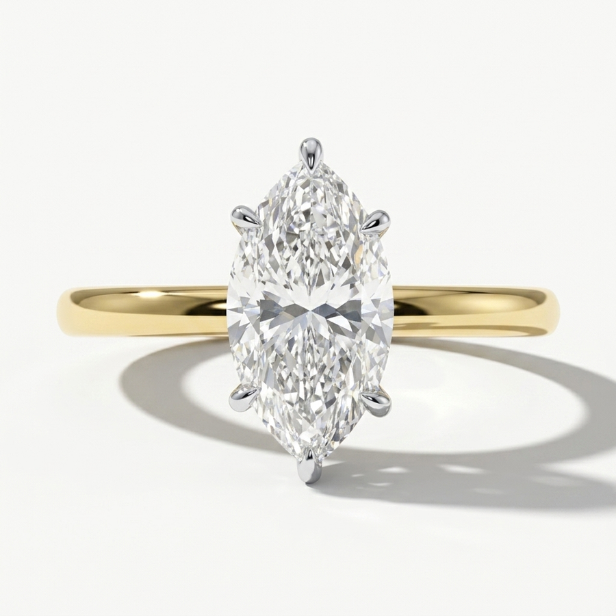 A yellow gold ring with a large marquise-cut diamond center stone, shown on a clean white background with a soft shadow.