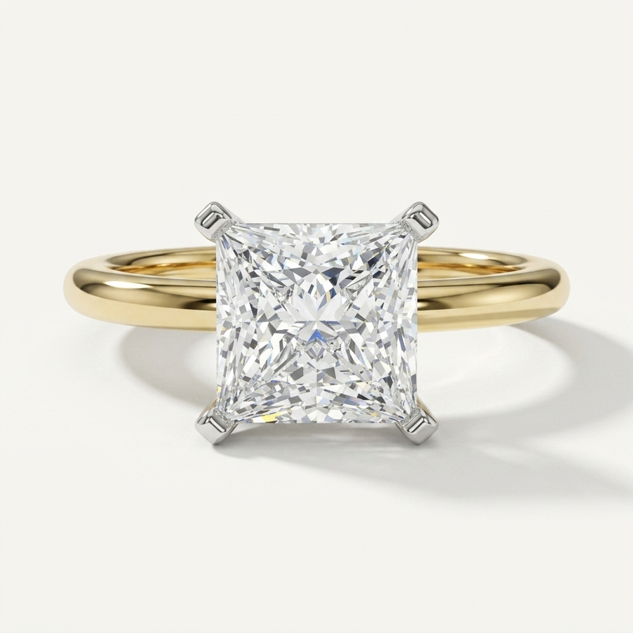 Princess cut diamond solitaire engagement ring on a petite yellow gold band