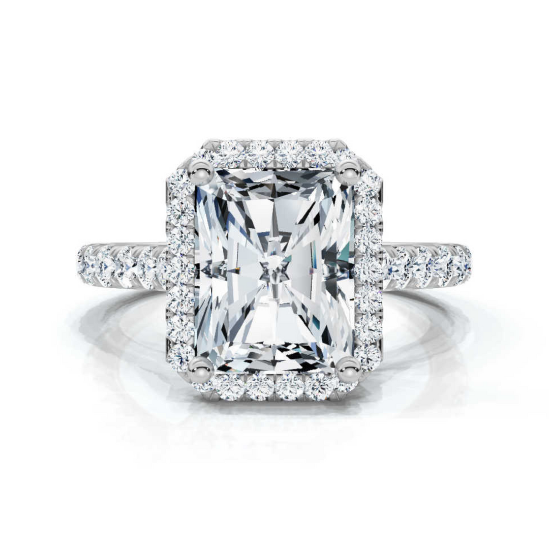 Stunning halo elongated radiant ring featuring a brilliant radiant-cut center diamond, surrounded by a shimmering halo for a timeless and sophisticated look.