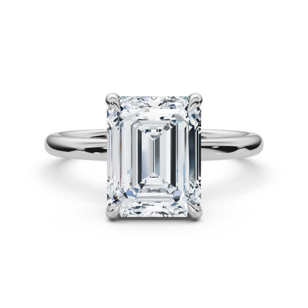 Elegant classic emerald solitaire ring featuring a striking emerald-cut diamond in a sleek, timeless setting for a sophisticated and refined look.