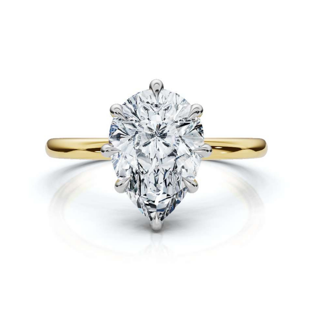 Timeless classic pear solitaire diamond ring, featuring a stunning pear-shaped center diamond set in a sleek four-prong setting, offering an elegant and sophisticated design perfect for engagements or special occasions.