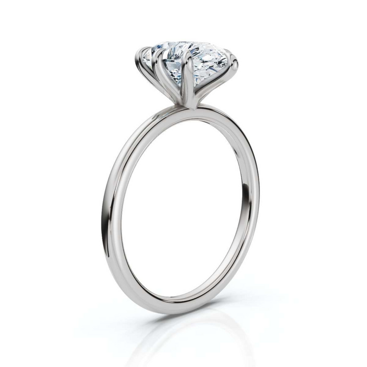 Timeless classic pear solitaire diamond ring, featuring a stunning pear-shaped center diamond set in a sleek four-prong setting, offering an elegant and sophisticated design perfect for engagements or special occasions.