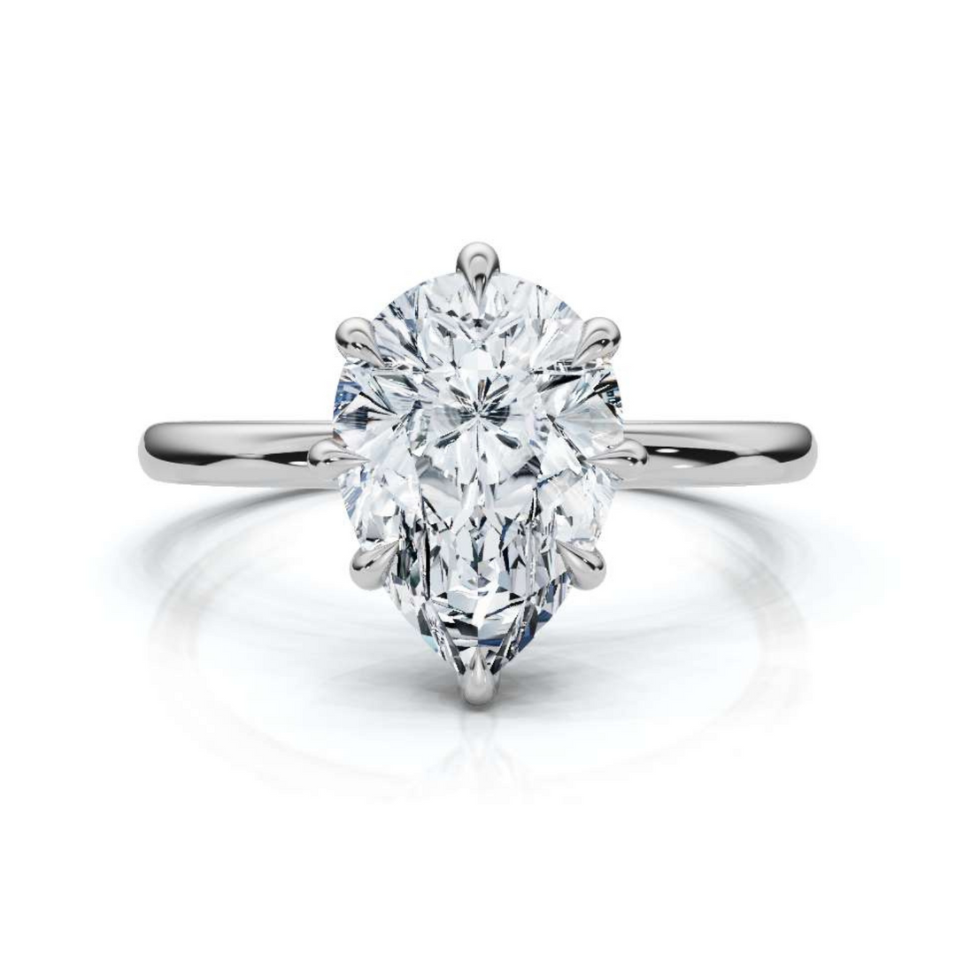 Timeless classic pear solitaire diamond ring, featuring a stunning pear-shaped center diamond set in a sleek four-prong setting, offering an elegant and sophisticated design perfect for engagements or special occasions.