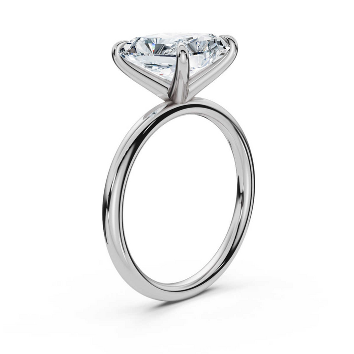 Elegant classic radiant solitaire diamond ring, featuring a brilliant radiant-cut center diamond set in a sleek four-prong setting, offering a sophisticated and timeless design perfect for engagements or special occasions.