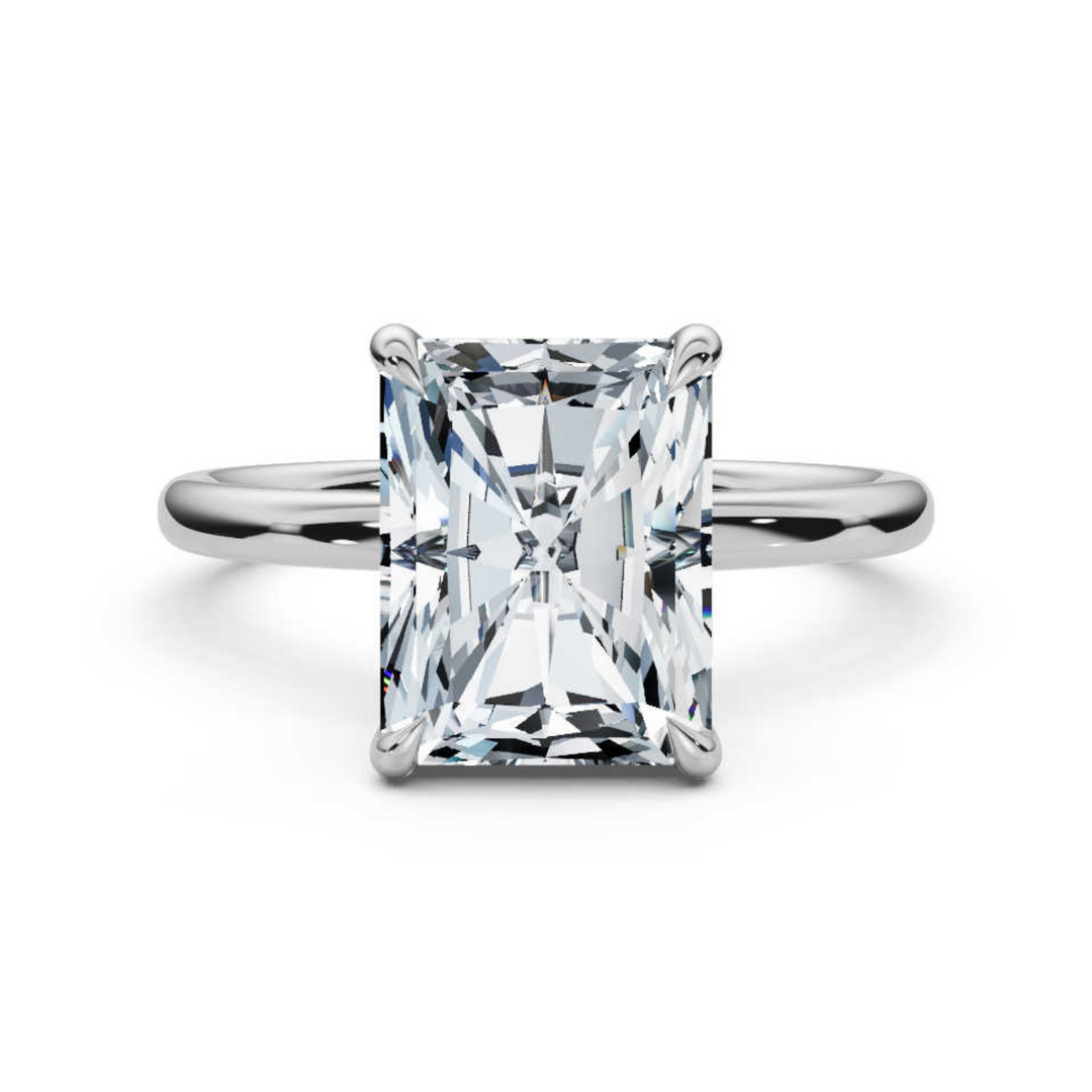 Elegant classic radiant solitaire diamond ring, featuring a brilliant radiant-cut center diamond set in a sleek four-prong setting, offering a sophisticated and timeless design perfect for engagements or special occasions.