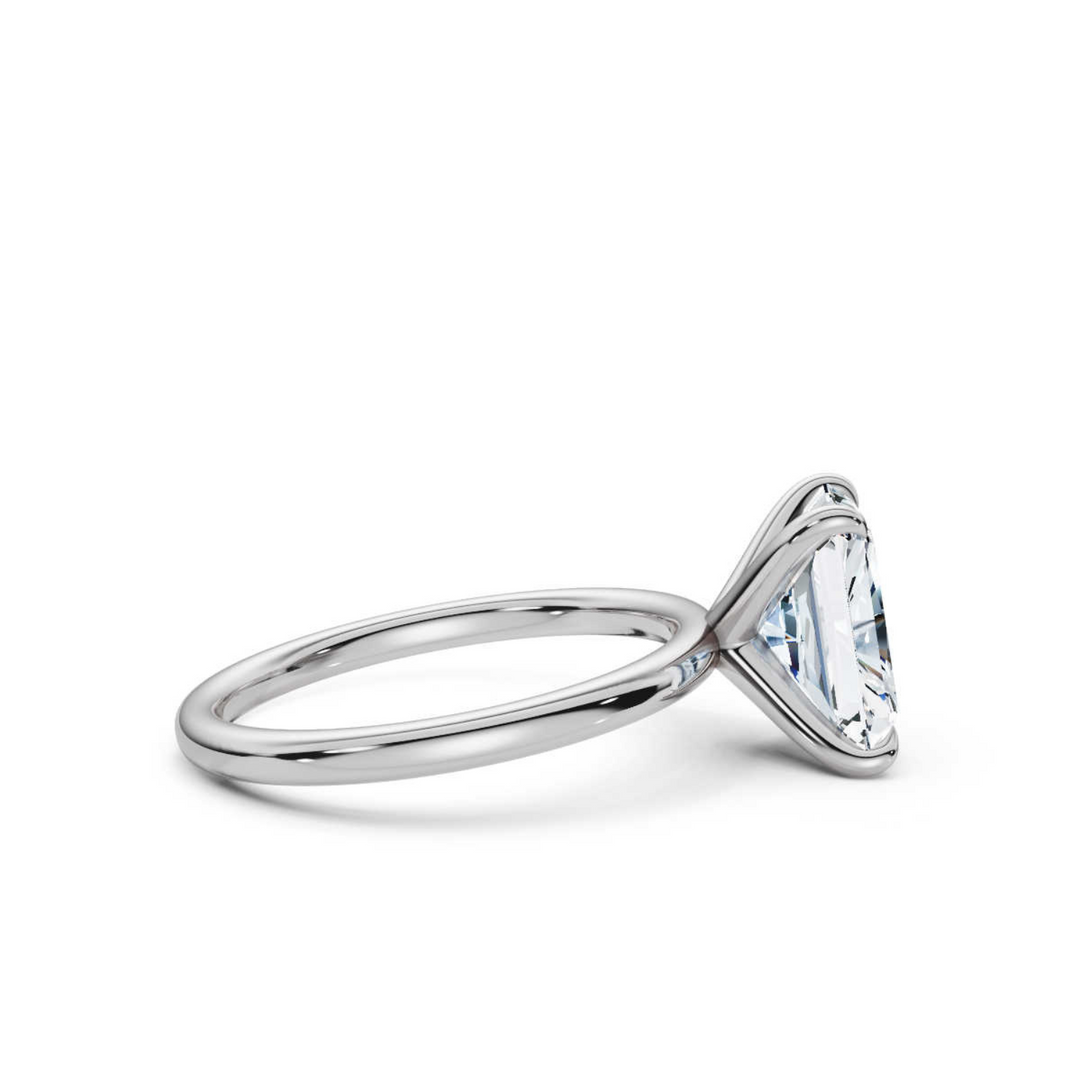 Elegant classic radiant solitaire diamond ring, featuring a brilliant radiant-cut center diamond set in a sleek four-prong setting, offering a sophisticated and timeless design perfect for engagements or special occasions.