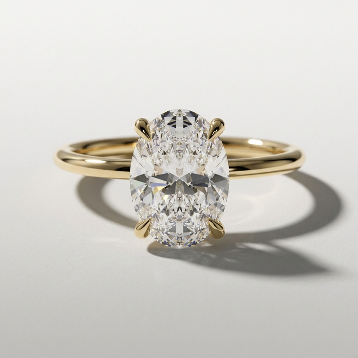 Oval diamond solitaire engagement ring with a petite hidden halo