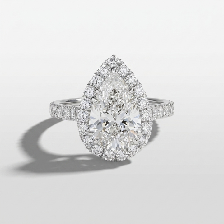 Pear diamond halo engagement ring on a solid band