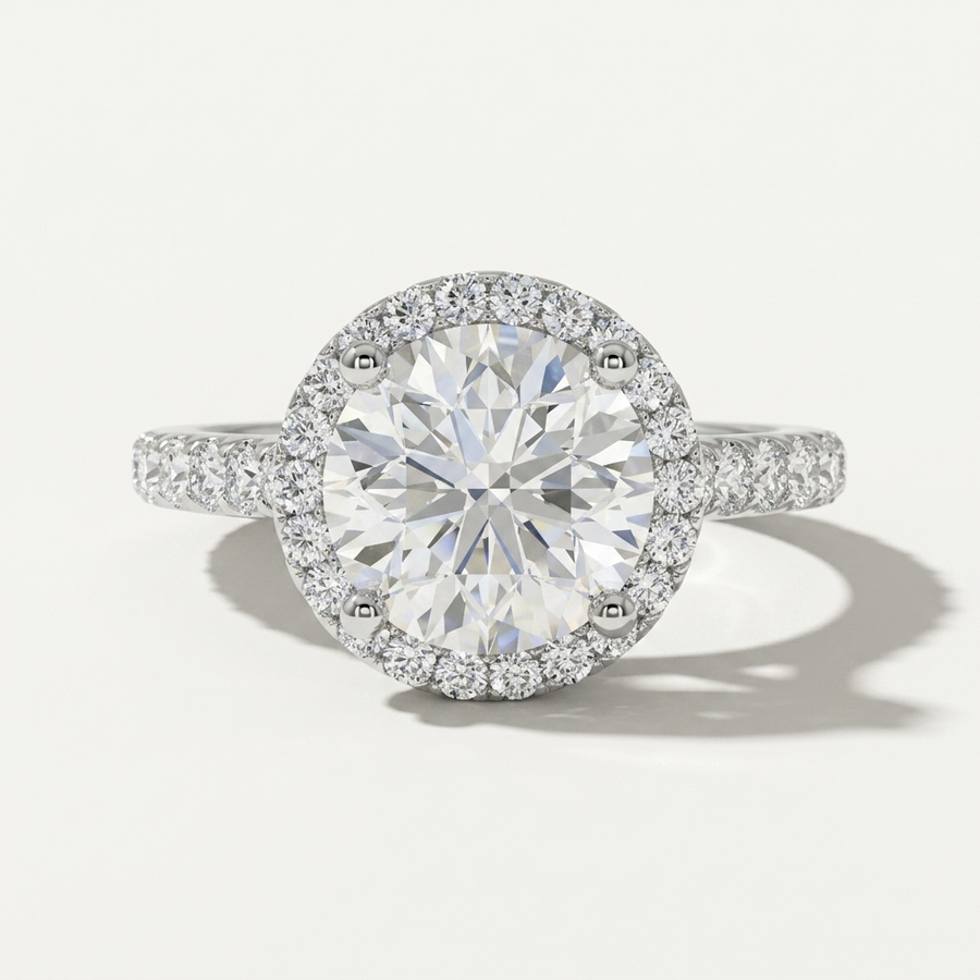 Round diamond halo engagement ring with a delicate diamond band