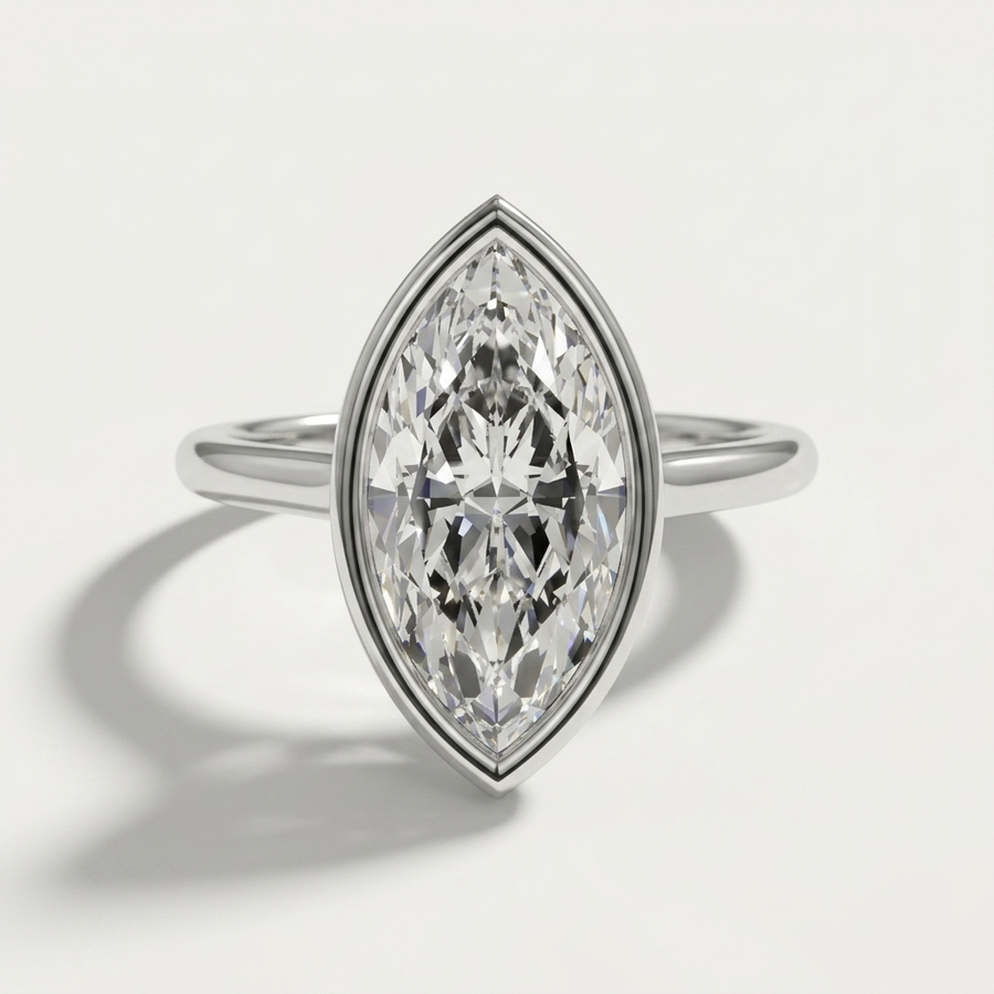 Bezel set marquise diamond solitaire engagement ring on a petite white gold band