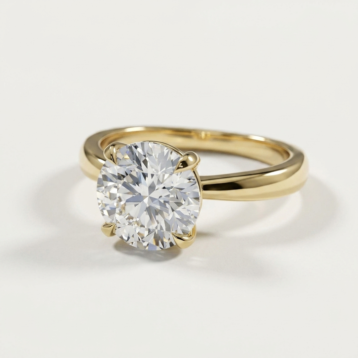 Round diamond pinched solitaire yellow gold engagement ring, side view