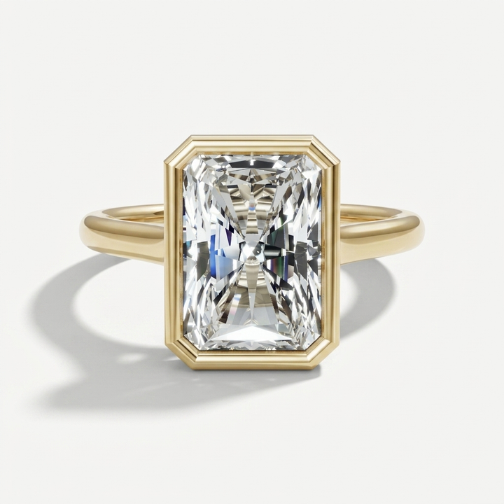 Bezel set radiant cut diamond solitaire engagement ring on a minimal band