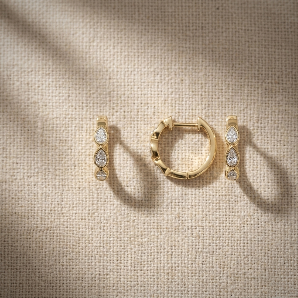 Chic 0.60ctw pear-shaped diamond hoop earrings in yellow gold, combining classic style with brilliant sparkle