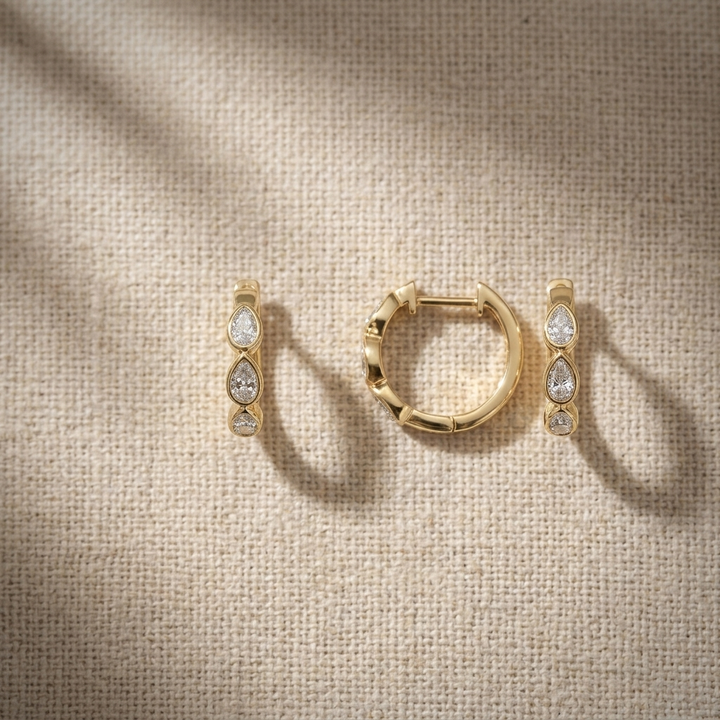 Chic 0.60ctw pear-shaped diamond hoop earrings in yellow gold, combining classic style with brilliant sparkle