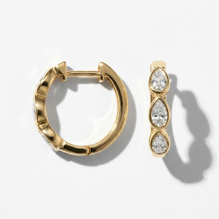 Chic 0.60ctw pear-shaped diamond hoop earrings in yellow gold, combining classic style with brilliant sparkle