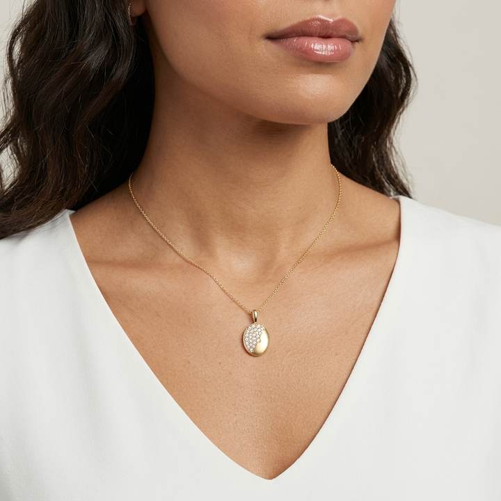 Beautiful oval-cut diamond burnish-set necklace in yellow gold, adding radiant sparkle to any occasion