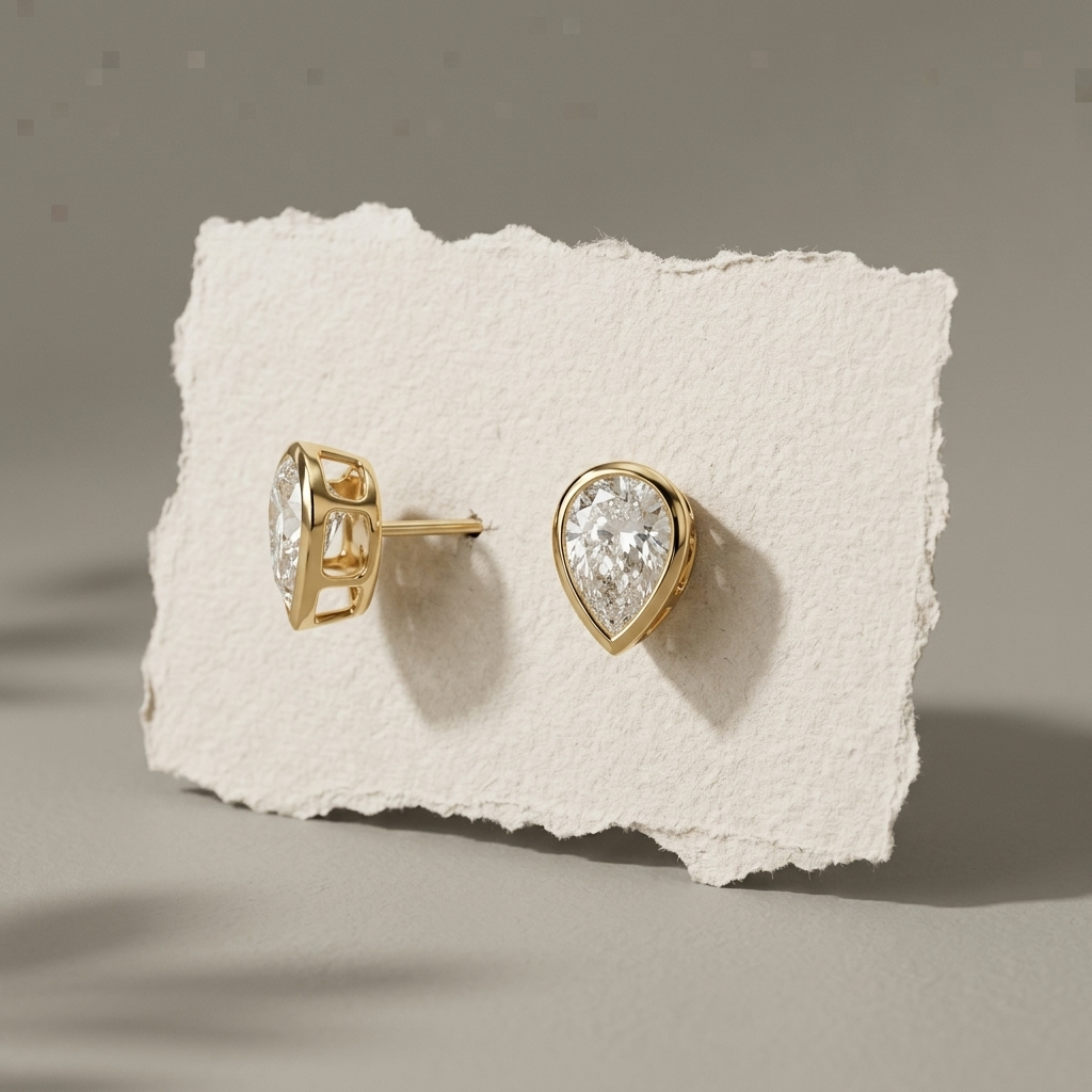 Classic 2.00ctw pear-shaped lab grown diamond bezel-set stud earrings, a timeless classic for everyday elegance