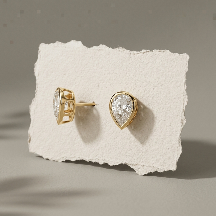 Classic 2.00ctw pear-shaped lab grown diamond bezel-set stud earrings, a timeless classic for everyday elegance