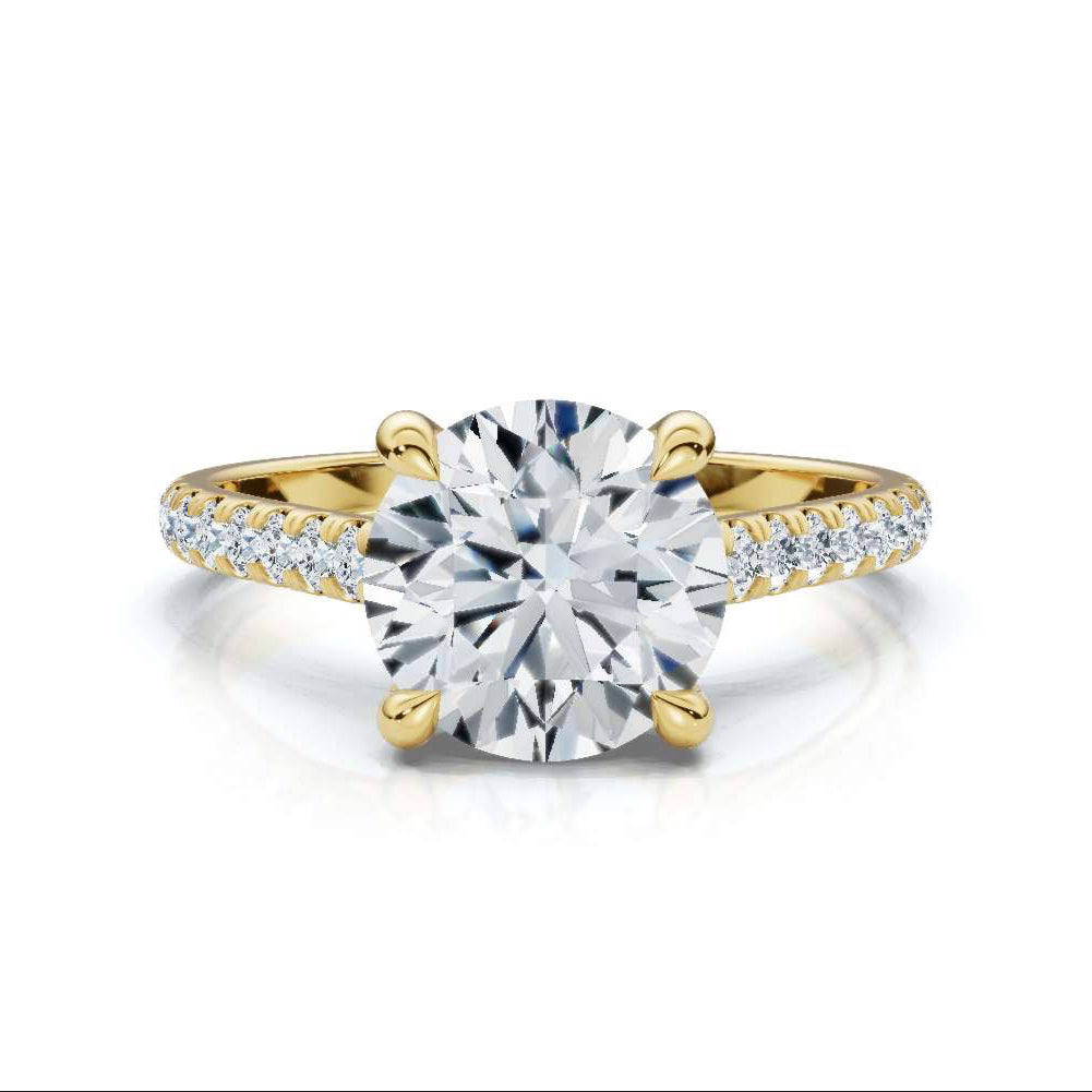Gold ring with a large diamond and smaller diamonds on the band against a white background