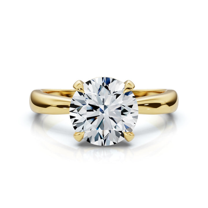 Gold ring with a large diamond on a white background