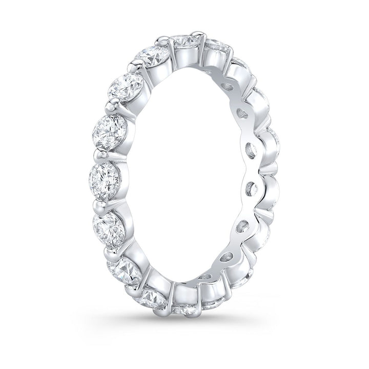 Stunning eternity band featuring round-cut diamonds in a delicate single prong setting, creating a seamless and elegant display of brilliance.